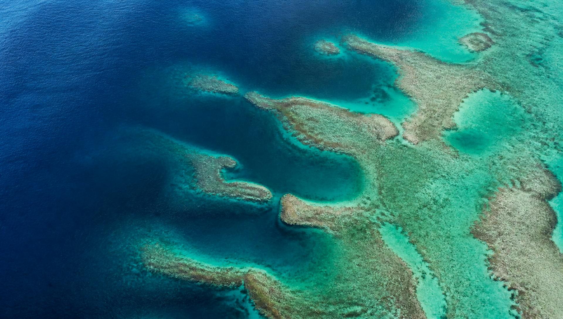 Aerial view of a turquoise reef and ocean channels
